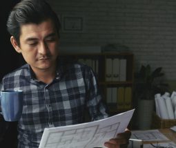 Frustrated business owner researching integrated creative agency solutions to fix underperforming design and marketing divisions